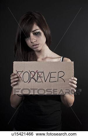 Stock Photograph - Crying teenage girl holding over sign. Fotosearch