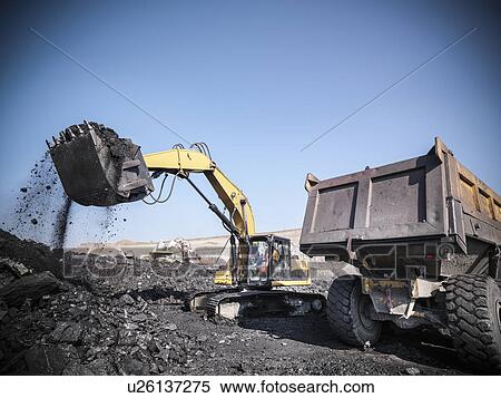 Digger scooping coal at mine View Large Photo Image Stock Photography - Digger scooping coal at mine. Fotosearch