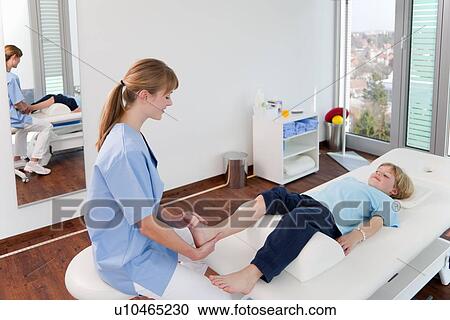 Doctor examining boys feet in office View Large Photo Image Stock Image - Doctor examining boys feet in office. Fotosearch