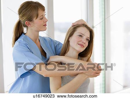 Stock Image - Doctor examining girl in office. Fotosearch