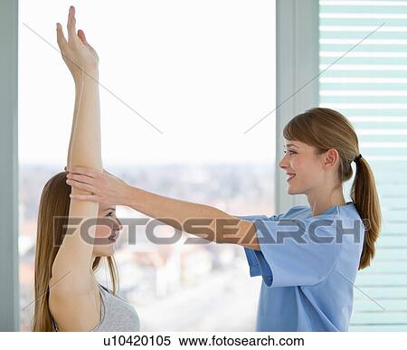 Doctor examining girls arms in office View Large Photo Image Stock Photography - Doctor examining girls arms in office. Fotosearch