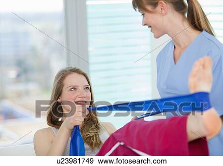 Stock Photo - Doctor examining girls legs in office. Fotosearch