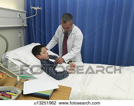 Doctor examining patient in hospital View Large Photo Image Stock Image - Doctor examining patient in hospital. Fotosearch