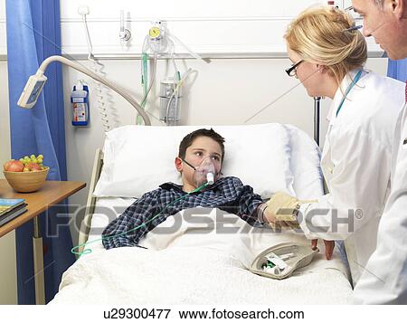 Stock Photo - Doctor examining patient in hospital. Fotosearch