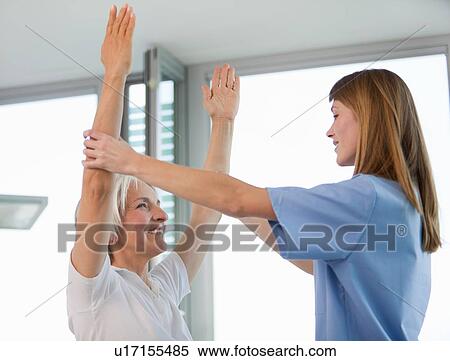 Stock Photography - Doctor examining womans arms in office. Fotosearch