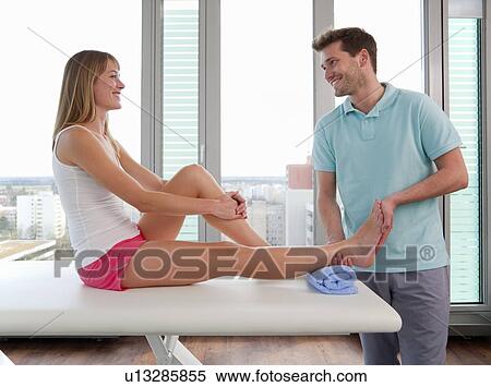 Doctor examining womans feet in office View Large Photo Image Stock Photography - Doctor examining womans feet in office. Fotosearch