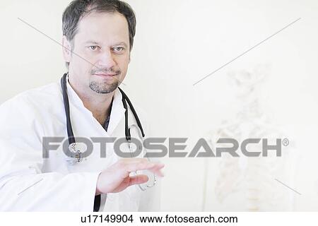 Picture - Doctor wearing stethoscope. Fotosearch