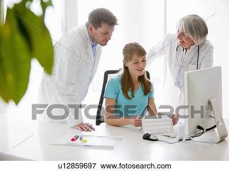 Doctors talking to receptionist View Large Photo Image Stock Photo - Doctors talking to receptionist. Fotosearch