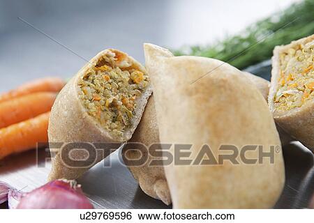 Empanadas (Latin American pasties) filled with a mixture of cooked maize, vegetables, and herbs View Large Photo Image Stock Photograph - Empanadas (Latin American pasties) filled with a mixture of cooked maize, vegetables, and herbs. Fotosearch