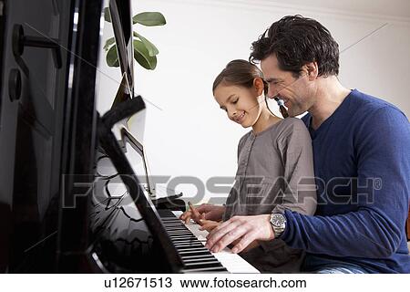 Father and daughter playing piano View Large Photo Image Stock Image - Father and daughter playing piano. Fotosearch