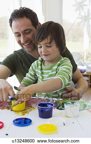 Father and son finger painting together View Large Photo Image Stock Image - Father and son finger painting together. Fotosearch