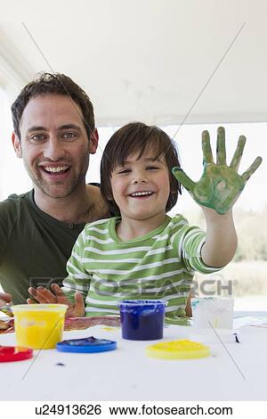 Father and son finger painting together View Large Photo Image Stock Photograph - Father and son finger painting together. Fotosearch