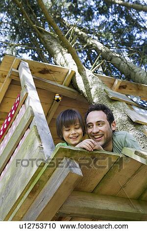 Father and son playing in tree house View Large Photo Image Stock Image - Father and son playing in tree house. Fotosearch