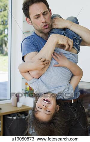 Stock Image - Father and son playing outdoors. Fotosearch