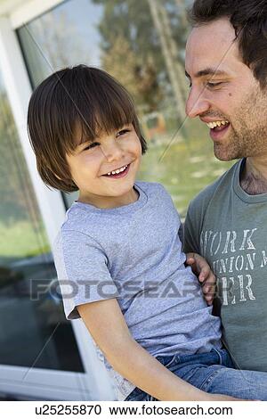 Father carrying son on porch View Large Photo Image Stock Image - Father carrying son on porch. Fotosearch
