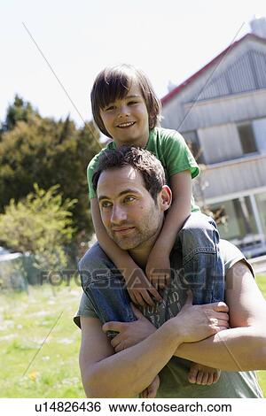 Father carrying son on shoulders View Large Photo Image Stock Photograph - Father carrying son on shoulders. Fotosearch