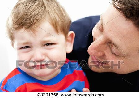 Father comforting crying son View Large Photo Image Stock Photo - Father comforting crying son. Fotosearch