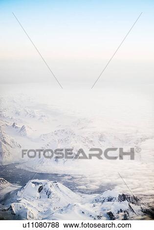 Fog rolling over snowy mountains, Greenland View Large Photo Image Stock Photo - Fog rolling over snowy mountains, Greenland. Fotosearch