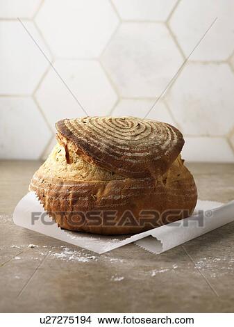Picture - Freshly baked bread in paper. Fotosearch