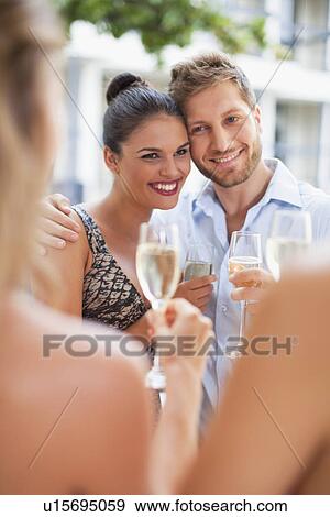 Friends drinking champagne together View Large Photo Image Stock Photo - Friends drinking champagne together. Fotosearch