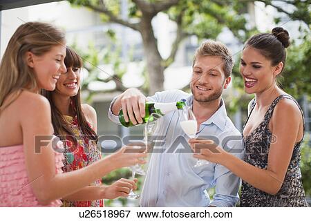Friends drinking champagne together View Large Photo Image Stock Photo - Friends drinking champagne together. Fotosearch