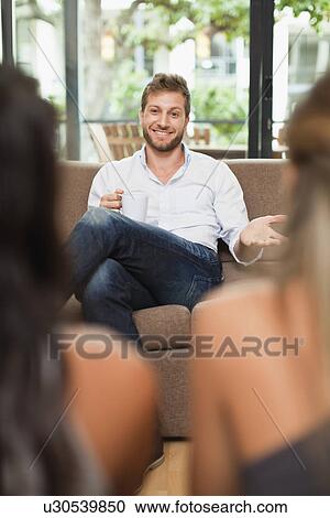 Stock Image - Friends having coffee together. Fotosearch