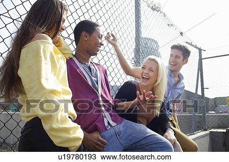 Friends laughing on city street View Large Photo Image Stock Image - Friends laughing on city street. Fotosearch
