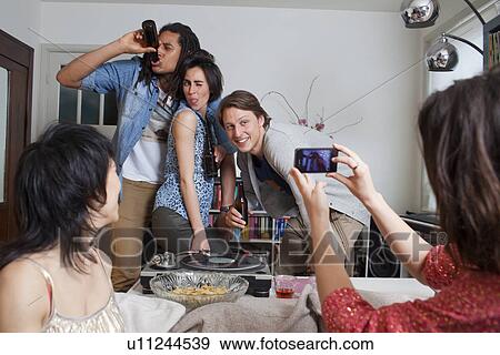 Friends taking pictures of themselves View Large Photo Image Stock Photo - Friends taking pictures of themselves. Fotosearch