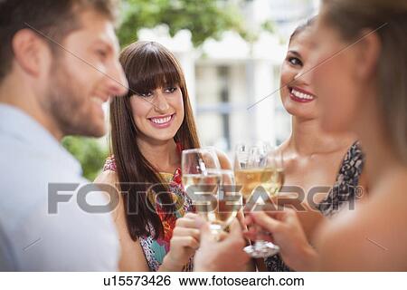 Friends toasting each other at party View Large Photo Image Stock Photograph - Friends toasting each other at party. Fotosearch