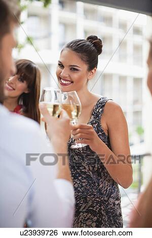 Friends toasting each other at party View Large Photo Image Stock Photograph - Friends toasting each other at party. Fotosearch