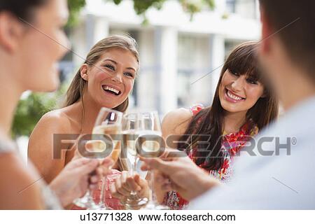 Stock Photo - Friends toasting each other. Fotosearch