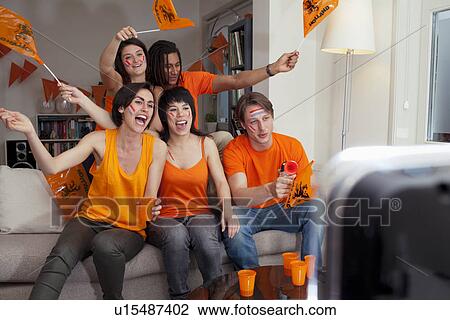 Friends watching sports on television View Large Photo Image Stock Image - Friends watching sports on television. Fotosearch
