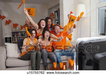 Stock Image - Friends watching sports on television. Fotosearch