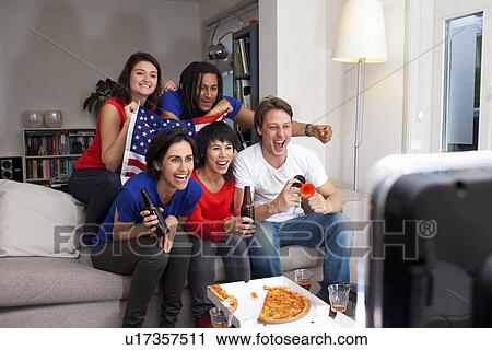 Stock Image - Friends watching sports on television. Fotosearch