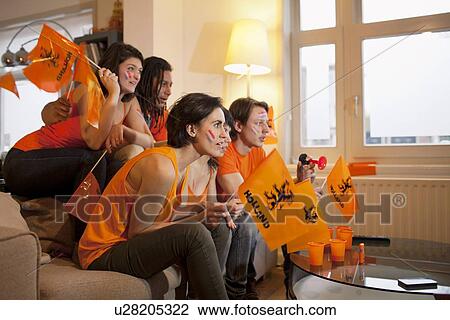 Friends watching sports on television View Large Photo Image Stock Image - Friends watching sports on television. Fotosearch