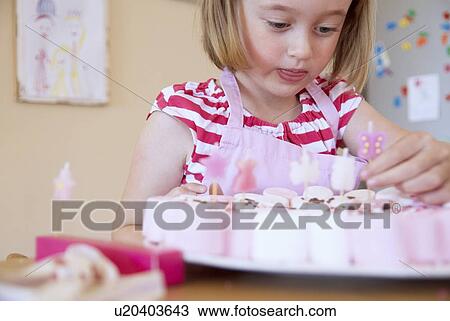 Stock Image - Girl baking in kitchen. Fotosearch
