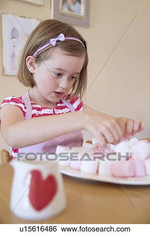 Stock Photograph - Girl baking in kitchen. Fotosearch