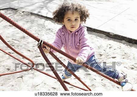 Girl climbing ropes in playground View Large Photo Image Stock Photo - Girl climbing ropes in playground. Fotosearch