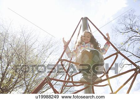 Girl climbing ropes in playground View Large Photo Image Stock Photo - Girl climbing ropes in playground. Fotosearch
