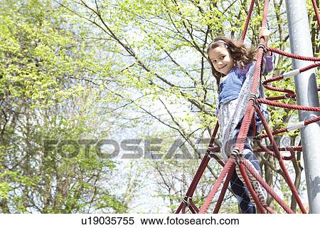 Girl climbing ropes in playground View Large Photo Image Stock Photography - Girl climbing ropes in playground. Fotosearch