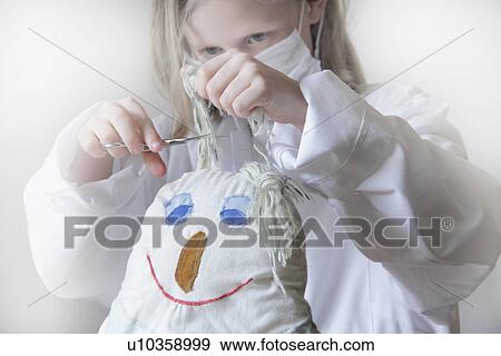 Girl cutting dolls hair View Large Photo Image Stock Photo - Girl cutting dolls hair. Fotosearch
