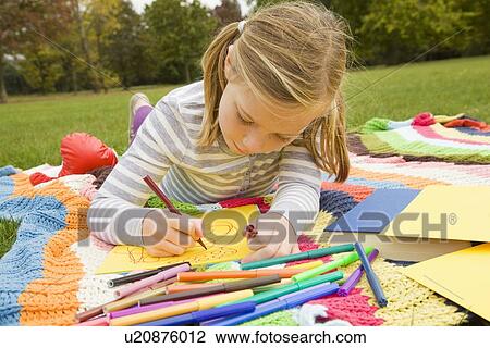 Girl drawing on picnic blanket View Large Photo Image Stock Image - Girl drawing on picnic blanket. Fotosearch