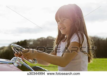 Girl driving toy airplane in field View Large Photo Image Picture - Girl driving toy airplane in field. Fotosearch