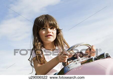 Girl driving toy airplane in field View Large Photo Image Stock Image - Girl driving toy airplane in field. Fotosearch