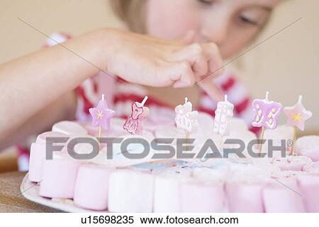 Girl examining decorated candies View Large Photo Image Stock Photography - Girl examining decorated candies. Fotosearch
