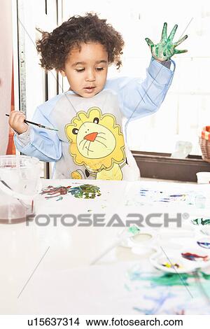 Girl finger painting on paper View Large Photo Image Picture - Girl finger painting on paper. Fotosearch