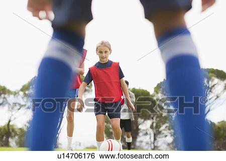 Girl playing soccer on pitch View Large Photo Image Stock Photograph - Girl playing soccer on pitch. Fotosearch