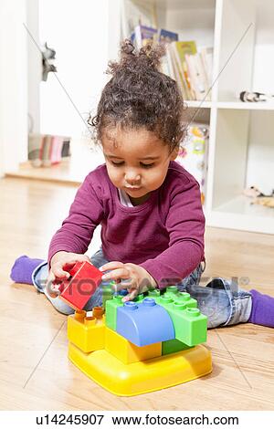 Girl playing with building blocks View Large Photo Image Stock Photo - Girl playing with building blocks. Fotosearch