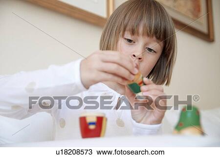 Girl playing with nesting doll View Large Photo Image Stock Image - Girl playing with nesting doll. Fotosearch