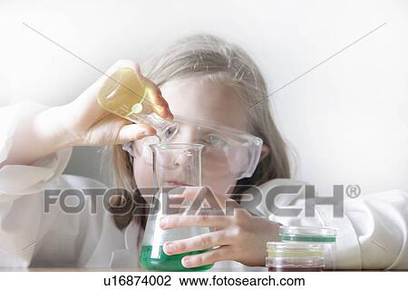 Girl pouring liquid into beakers View Large Photo Image Stock Image - Girl pouring liquid into beakers. Fotosearch